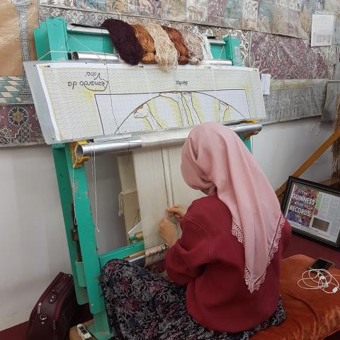 Turkish Woman Demonstrating Carpet Weaving