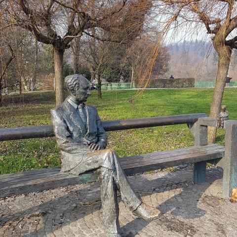 Statue of Edvard Kocbek, in Tivoli Park with view of Ljubljana